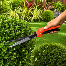 Load image into Gallery viewer, Person using garden shears to trim a bush