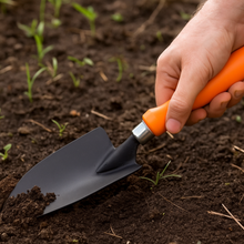 Load image into Gallery viewer, Hand holding a gardening trowel in soil with young plants