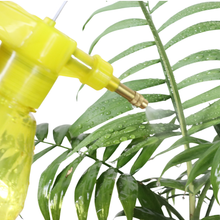 Load image into Gallery viewer, Yellow spray bottle watering a green plant with water droplets on leaves.