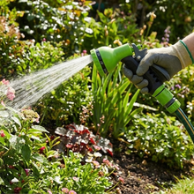 Load image into Gallery viewer, Person watering plants with a green Vinka garden hose in a garden setting
