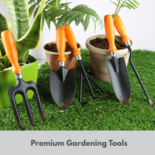 Load image into Gallery viewer, Gardening tools including a fork and two shovels with orange handles on grass with potted plants.
