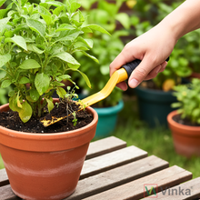 Load image into Gallery viewer, Person using a yellow vinka khurpa 1-inch gardening tool on a potted plant 
